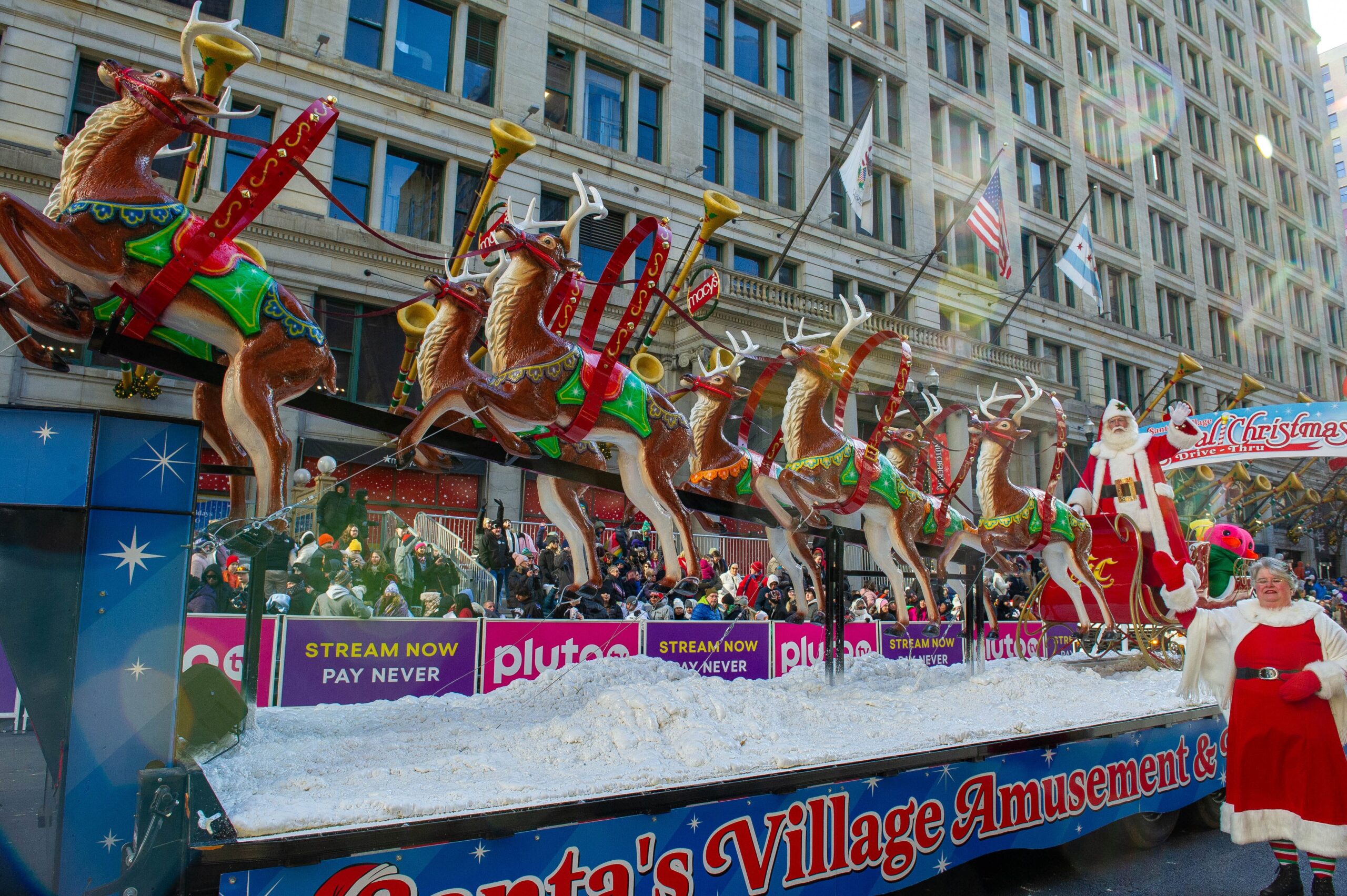 Santa and Mrs Claus with their reindeer float at the 2023 Chicago Thanksgiving Parade